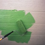 Roller Painting House Siding Green